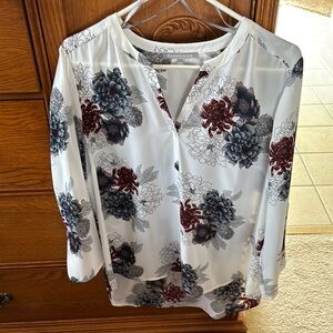 Pretty white blouse with colored flowers and stylish sleeves.  Never worn.